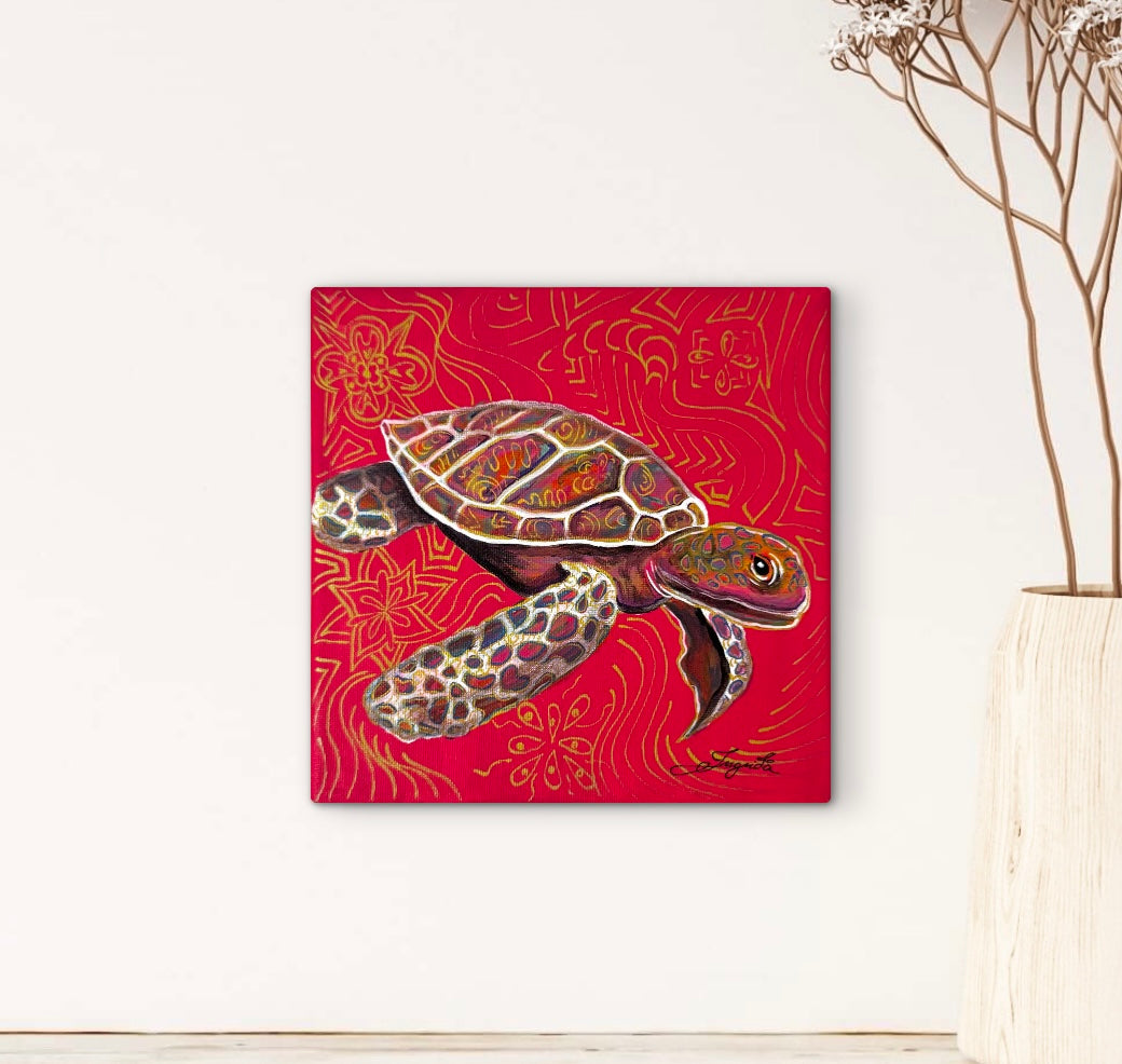 A-square-canvas-wall-art-print-featuring-a-painted-sea-turtle-on-a-vivid-red-background-with-gold-decorative-motifs-displayed-on-a-white-wall-next-to-a-vase-with-dried-branches.